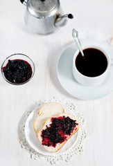 Bread with jam and cup of coffee