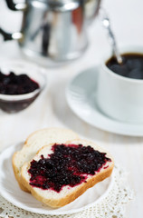 Bread with jam and cup of coffee