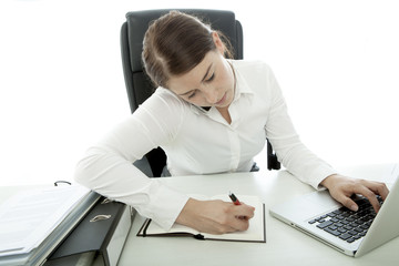 young brunette business woman is busy with telefon and laptop