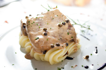 Meat with gravy and mashed potatoes