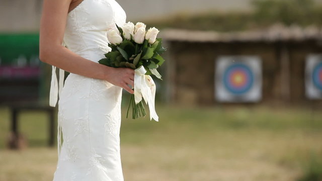 Bride standing with a bouquet and waiting for the groom
