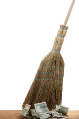 Broom sweep the dollars on white background