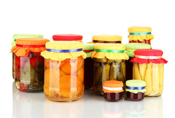 Jars with canned fruits and vegetables isolated on white