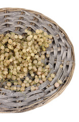 White currants on wicker mat isolated on white