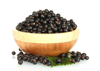 Fresh black currant in wooden bowl isolated on white