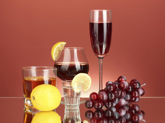 a variety of alcoholic drinks on red background
