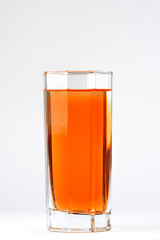 A glass with a red drink on a white background