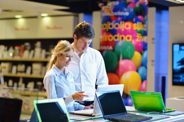 Young couple in consumer electronics store