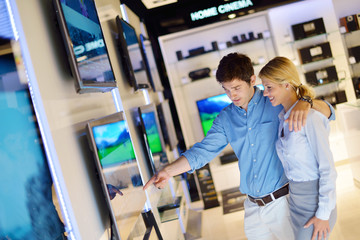 Young couple in consumer electronics store