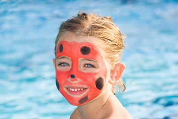 Girl with painted face by ladybug