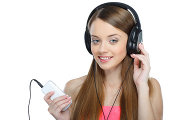 Beautiful girl with headphones listening music isolated  
