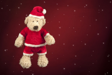 Christmas teddy bear in red star background
