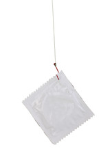Condom on hook isolated on white