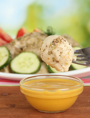 delicious dumpling dipped in sauce close-up