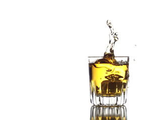 Golden cocktail with an ice cube