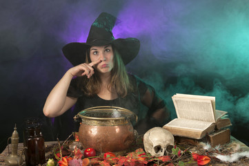 halloween witch with cauldron making funny faces