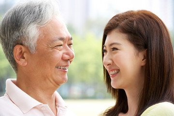 Portrait Of Chinese Father With Adult Daughter In Park