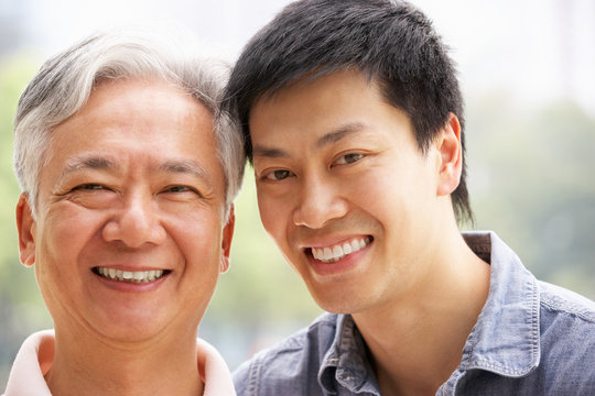 Portrait Of Chinese Father With Adult Son In Park