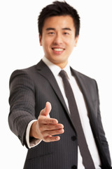 Portrait Of Chinese Businessman Reaching Out To Shake Hands