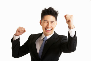 Studio Portrait Of Chinese Businessman Celebrating