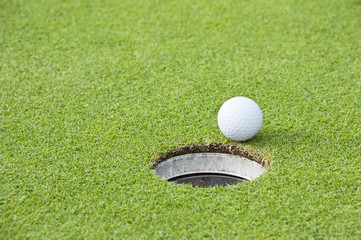 Golf Ball on Edge of Hole - 43934310