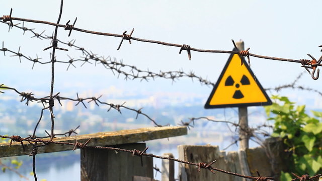 Radiation symbol and barbed wire.