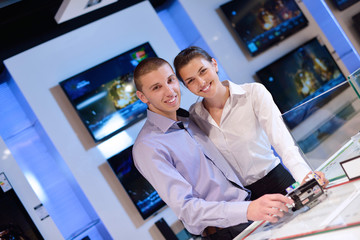 Young couple in consumer electronics store
