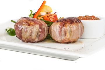 Grilled steak wrapped in bacon, with grilled vegetables, mashed