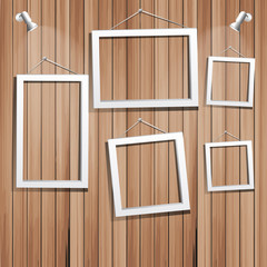 white frames on wooden wall. vector illustration.