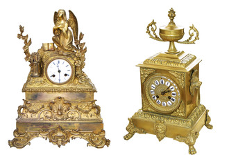Two Antique gold colored table clocks isolated on white background