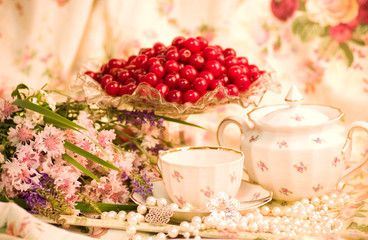 Vintage tea in elegant tableware, raspberry, cherry and flowers