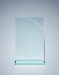 Blank glass award over gray background with copy space