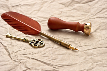 personal stamp, vintage quill and key