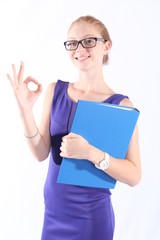 Pretty redhead woman holding a folder, doing the OK sign