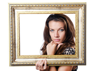 Young woman with picture frame on white