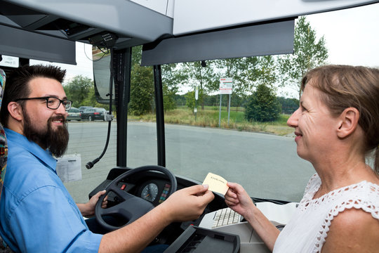 Busdriver and paying Woman laughing
