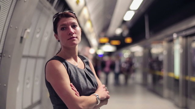 businesswoman waiting for a train in subway, steadicam shot