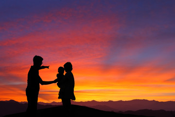 Naklejka na ściany i meble silhouette of family watching the sunrise
