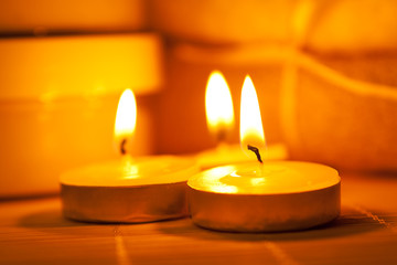 Fototapeta na wymiar Miniature candles on a bamboo mat