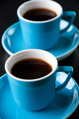 Close-up of two cups with black coffee, studio shot