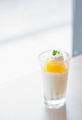 cup of orange panna cotta on the table