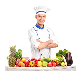 Male chef with fruits and vegetables on table