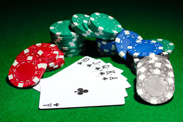 Cards and chips for poker on green table