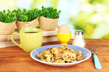 Fried zucchini with eggs and coffee for breakfast