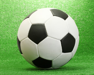 Fototapeta na wymiar football ball on artificial green grass