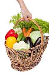Fresh vegetables in a basket on white.