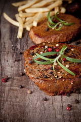 Delicious beef steaks on wooden table