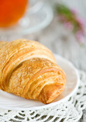 Croissant with cup of tea