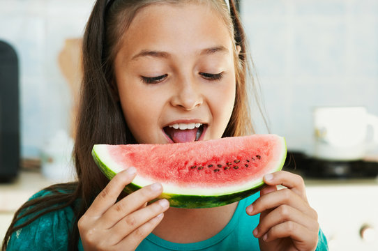 The girl is eating the watermelon