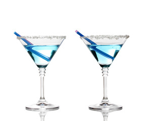 Blue cocktail in martini glasses isolated on white